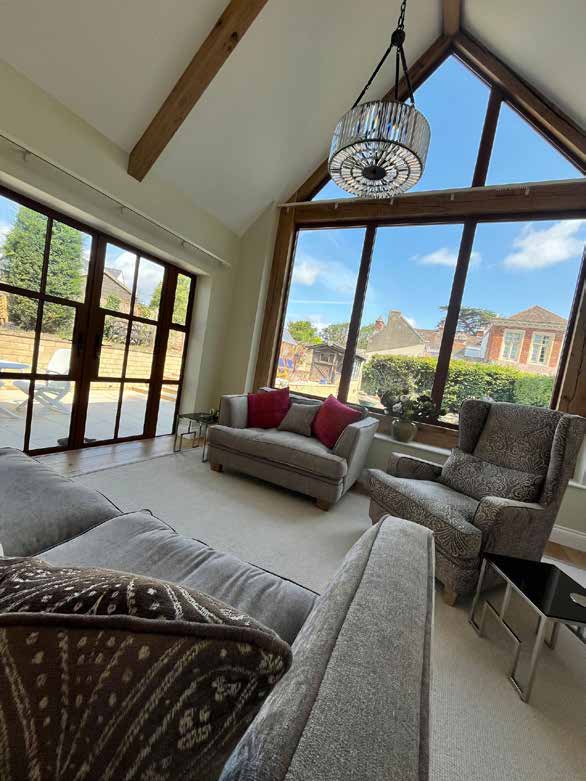 Vaulted ceiling with exposed oak beams and French doors