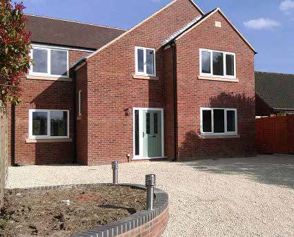 Three-home development – red brick house